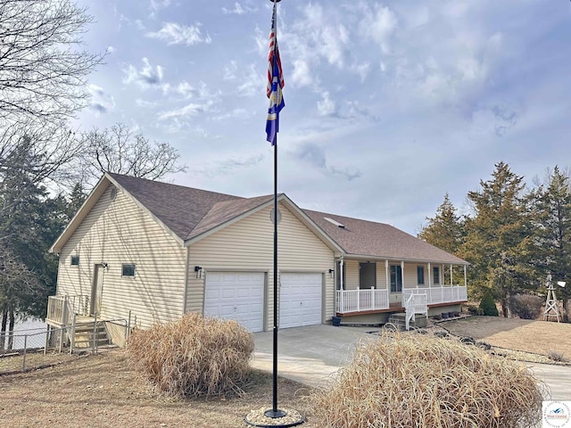 view of front facade featuring a garage, driveway, a porch, and roof with shingles