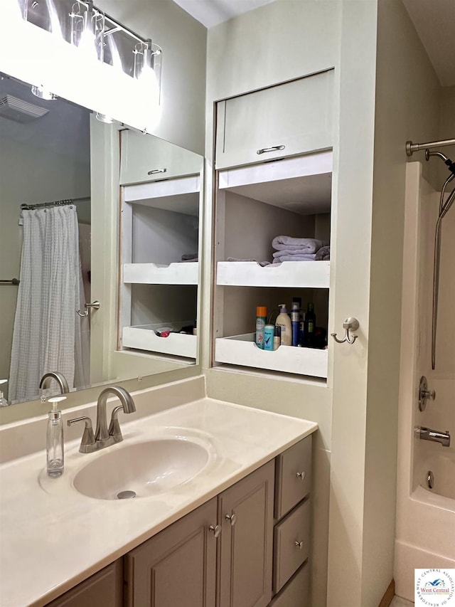 bathroom with visible vents, shower / bath combination with curtain, and vanity