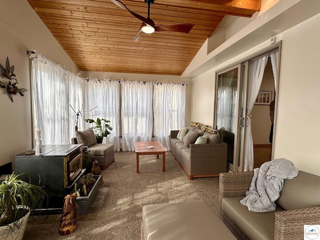 sunroom / solarium with a wood stove, wooden ceiling, ceiling fan, and vaulted ceiling