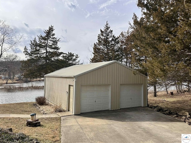 detached garage featuring a water view