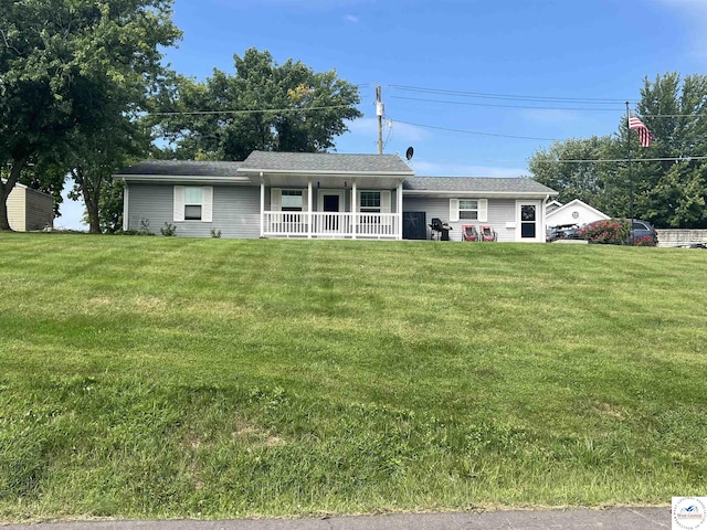 ranch-style house with a garage, a porch, and a front yard