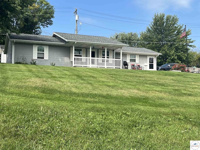 view of front of home featuring covered porch and a front lawn