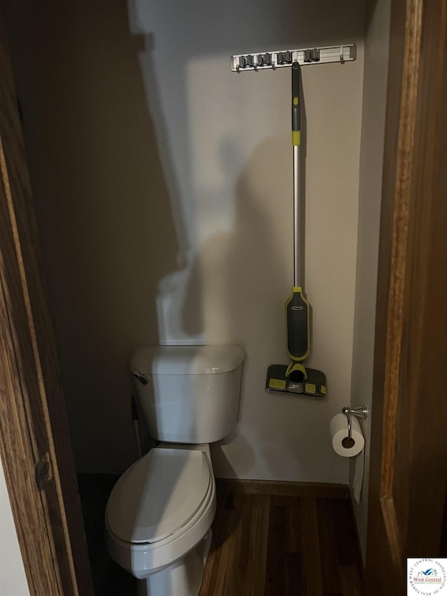 bathroom featuring baseboards, toilet, and wood finished floors