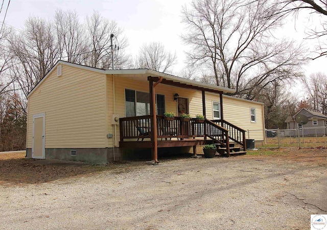 manufactured / mobile home with central AC, a porch, and fence