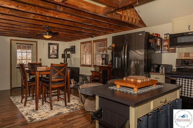 kitchen featuring dark countertops, black appliances, a kitchen island, dark wood finished floors, and white cabinetry