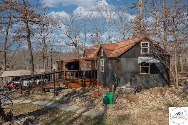 view of front facade featuring metal roof and a deck