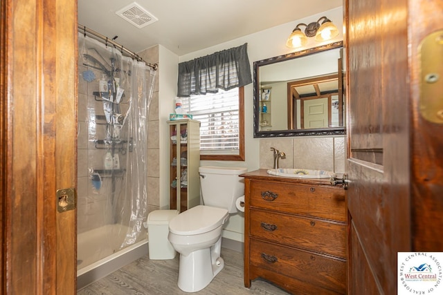 bathroom with visible vents, toilet, vanity, and a shower with curtain