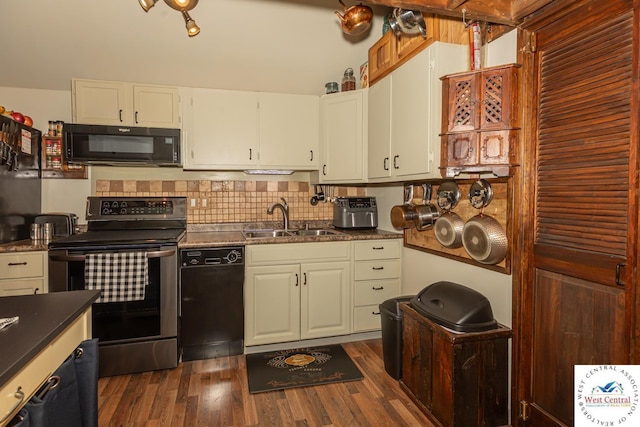 kitchen with a sink, tasteful backsplash, black appliances, and dark wood-style floors