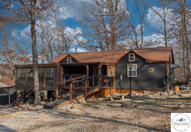 chalet / cabin with stairway and metal roof