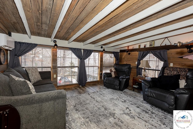 living area featuring beamed ceiling, wood finished floors, wooden ceiling, and a wall unit AC