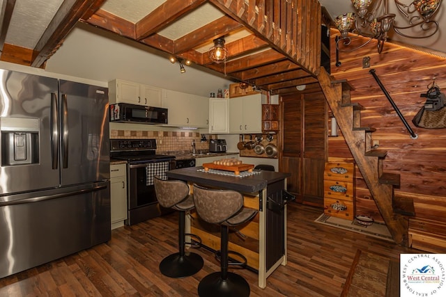 kitchen featuring dark wood-style flooring, range with electric cooktop, stainless steel refrigerator with ice dispenser, black microwave, and dark countertops