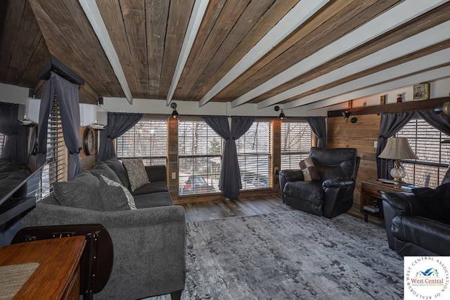 living area with beam ceiling, wooden ceiling, and wood finished floors