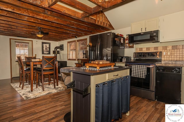 kitchen with dark wood-style floors, black appliances, white cabinetry, dark countertops, and backsplash