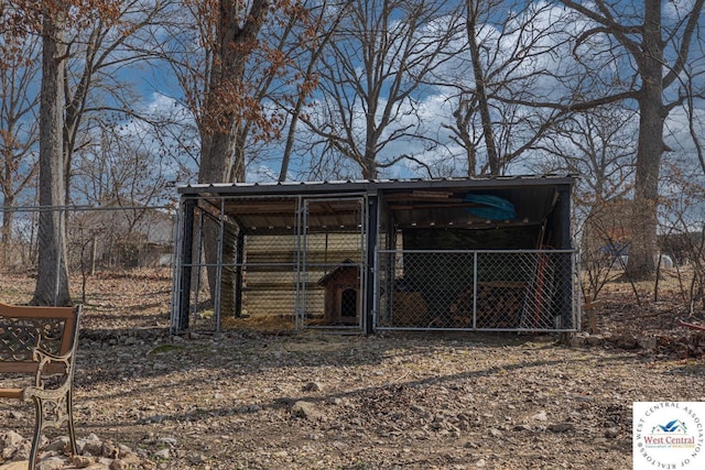 view of outbuilding featuring an outdoor structure and fence