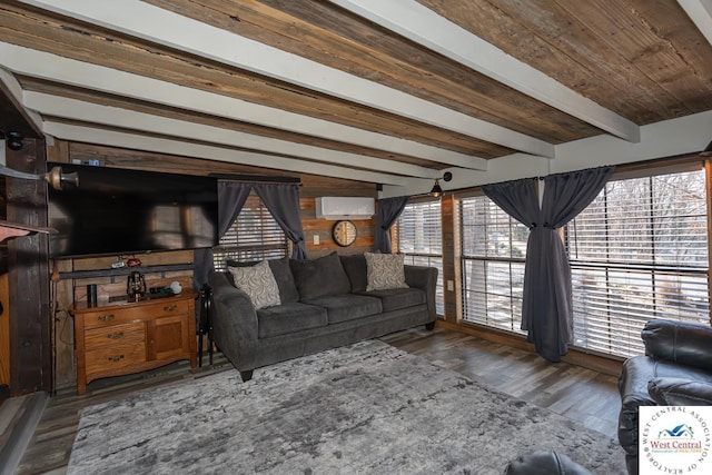 unfurnished living room featuring beam ceiling, an AC wall unit, and wood finished floors