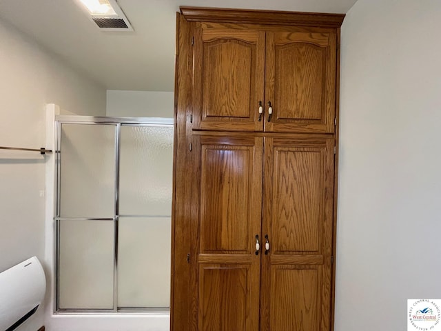 full bath featuring a closet, a shower stall, and visible vents