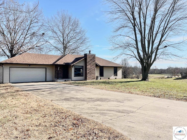 view of front of property with a chimney, a shingled roof, concrete driveway, an attached garage, and a front yard