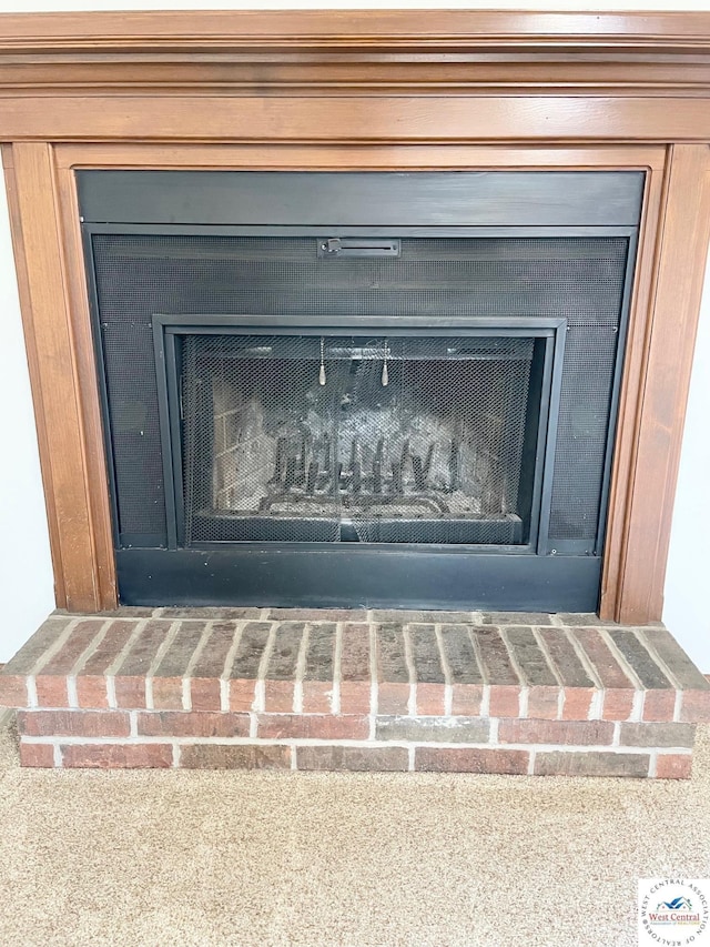 interior details with a fireplace with raised hearth