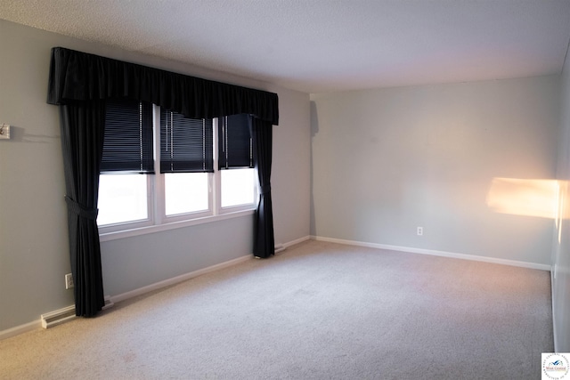 spare room featuring visible vents, baseboards, and light colored carpet