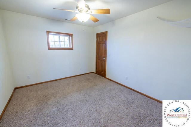 carpeted empty room featuring visible vents, a ceiling fan, and baseboards