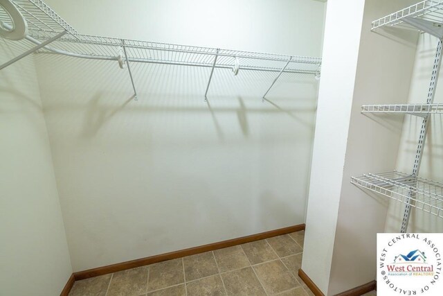 spacious closet with tile patterned flooring