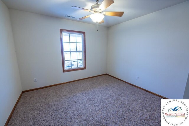 empty room with carpet floors, visible vents, baseboards, and a ceiling fan