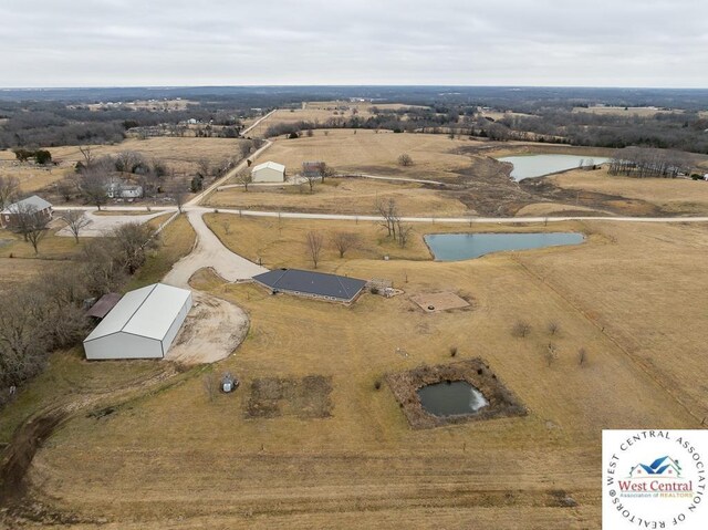 bird's eye view with a water view and a rural view