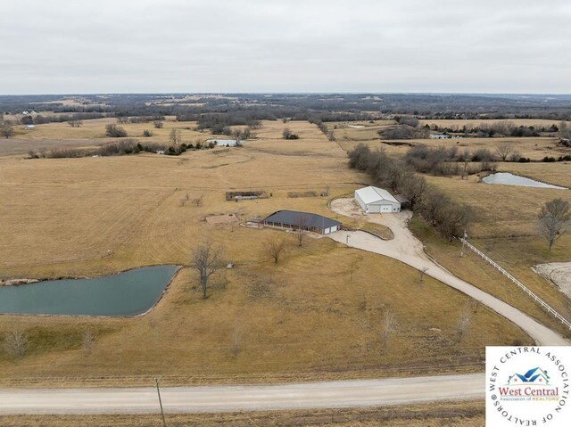 birds eye view of property featuring a rural view and a water view