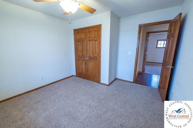 unfurnished bedroom with a closet, carpet flooring, a ceiling fan, and baseboards