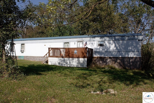 rear view of property with a lawn, cooling unit, and a wooden deck