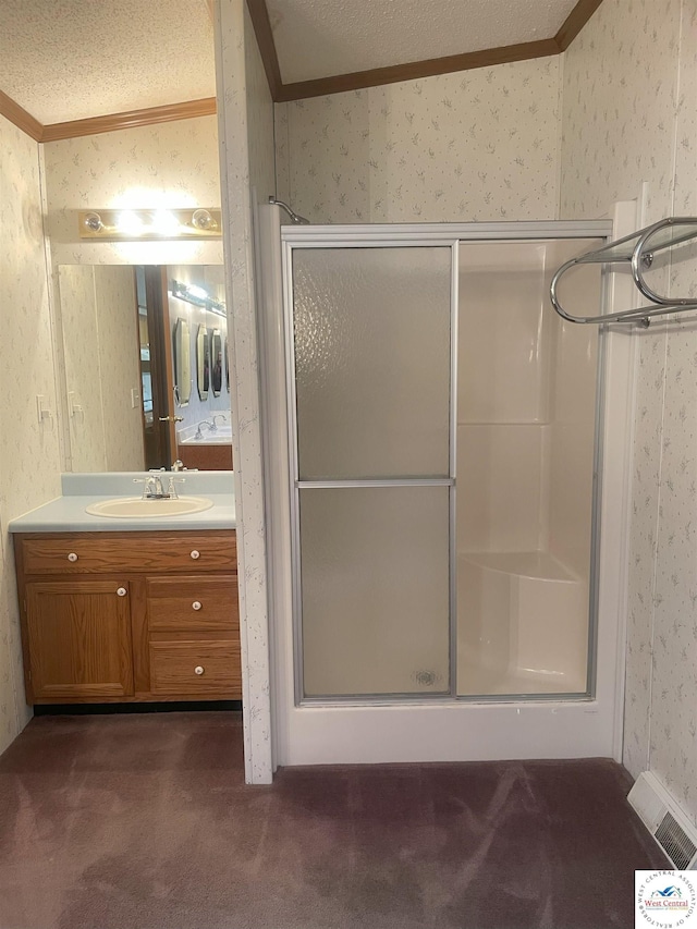 bathroom with vanity, visible vents, a shower stall, wallpapered walls, and crown molding