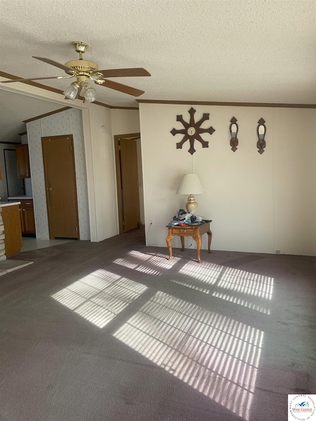 carpeted spare room with a textured ceiling and ornamental molding