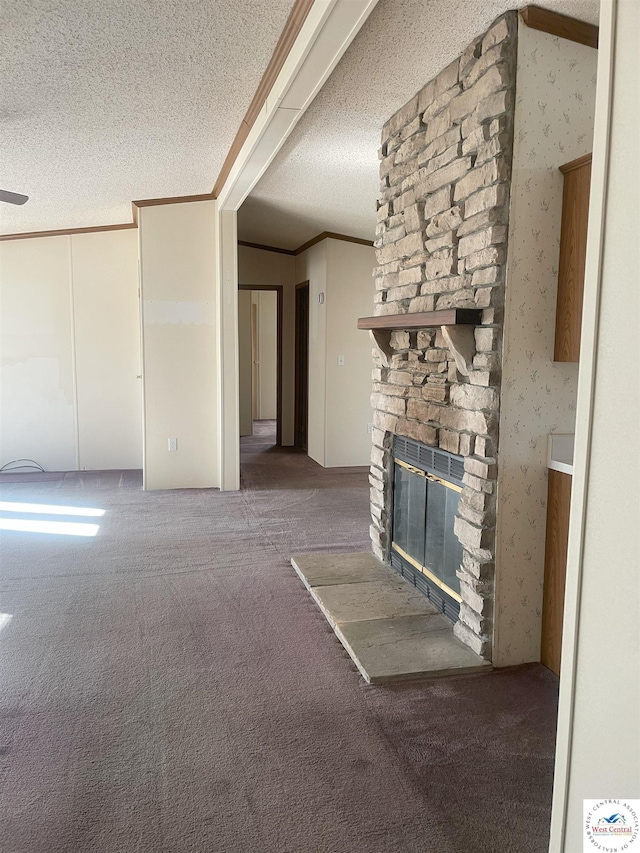 unfurnished living room with wallpapered walls, carpet, crown molding, a textured ceiling, and a fireplace