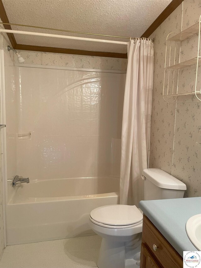 bathroom with toilet, shower / bath combo with shower curtain, vanity, a textured ceiling, and wallpapered walls