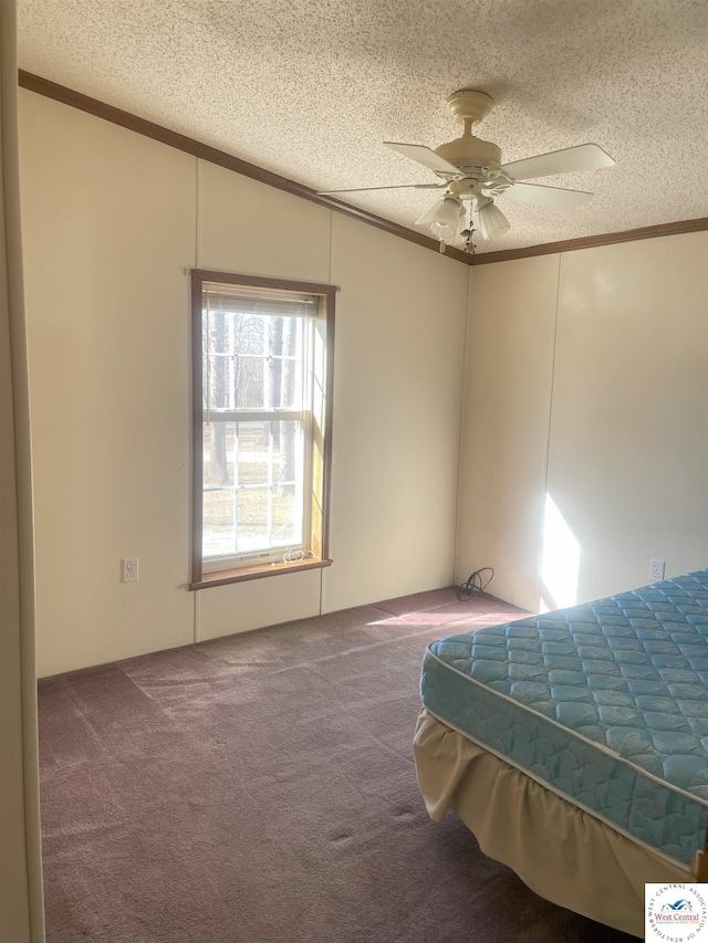 unfurnished bedroom with ornamental molding, carpet, and a textured ceiling