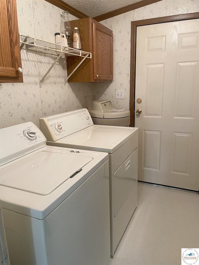 laundry area with cabinet space, independent washer and dryer, light floors, and wallpapered walls