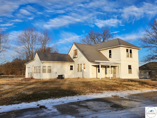 view of front of home with covered porch and central AC unit