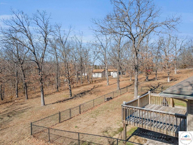 view of yard featuring fence and a wooden deck