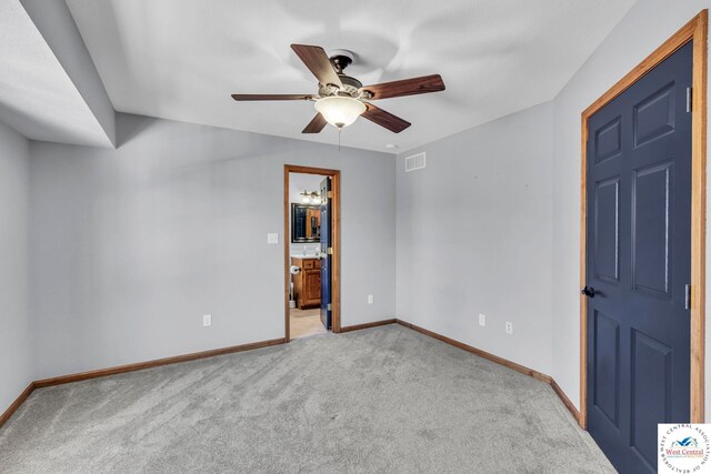 empty room featuring light carpet, ceiling fan, visible vents, and baseboards