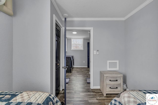 bedroom with crown molding, a textured ceiling, baseboards, and wood finished floors