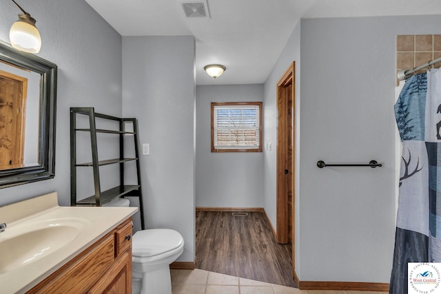 full bathroom featuring curtained shower, visible vents, toilet, vanity, and tile patterned floors