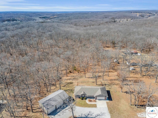 birds eye view of property with a view of trees