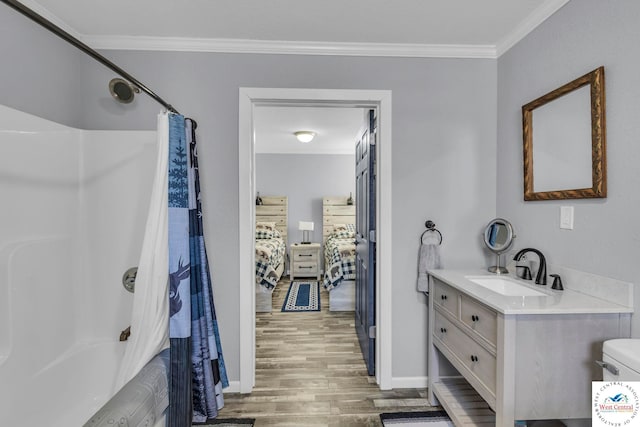 bathroom featuring ensuite bathroom, wood finished floors, vanity, shower / bath combo with shower curtain, and crown molding