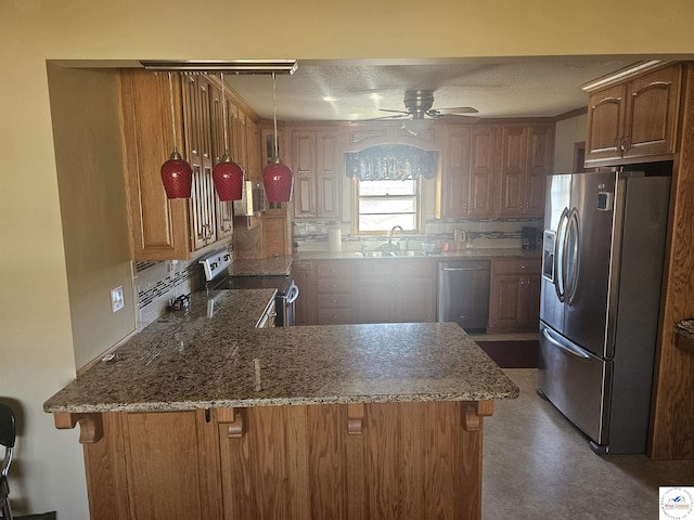 kitchen with a sink, decorative backsplash, stone countertops, and stainless steel appliances