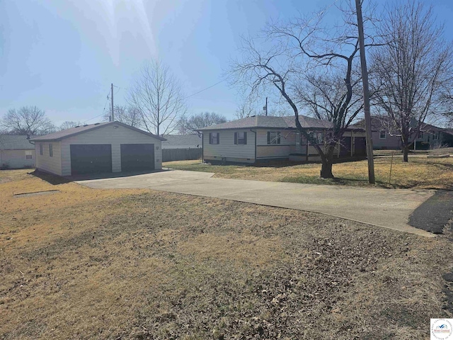 ranch-style house with a front yard, a detached garage, an outdoor structure, and fence