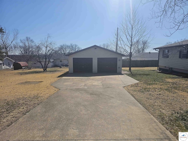 detached garage featuring fence