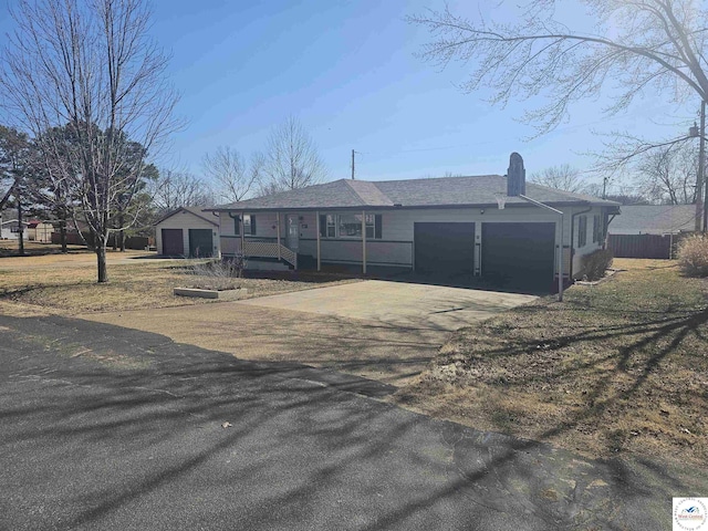 view of front of home featuring an attached garage, driveway, and fence