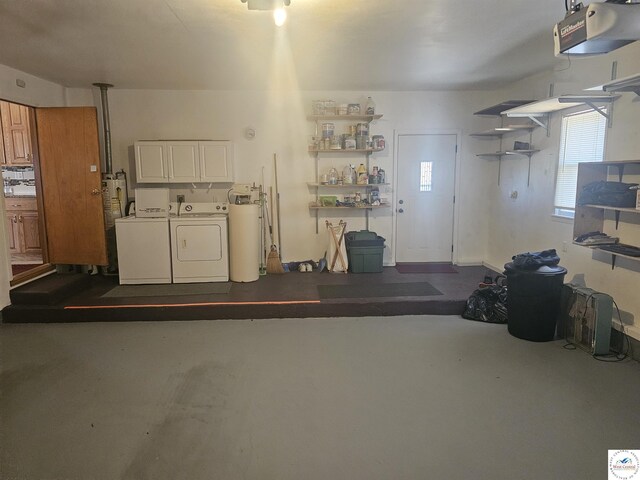 garage with independent washer and dryer and a garage door opener