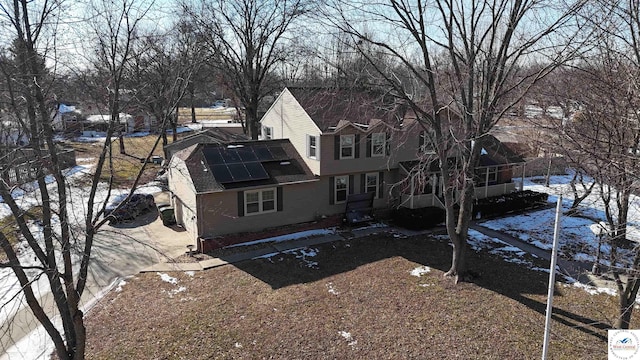 view of front facade featuring roof mounted solar panels