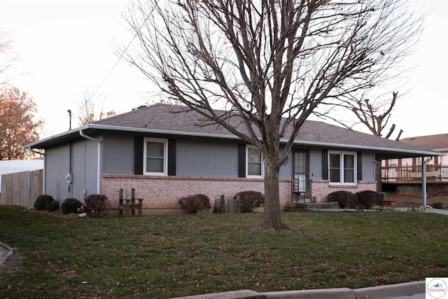 exterior space with brick siding and a front lawn